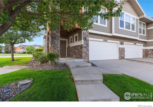 view of front of home with a front yard and a garage