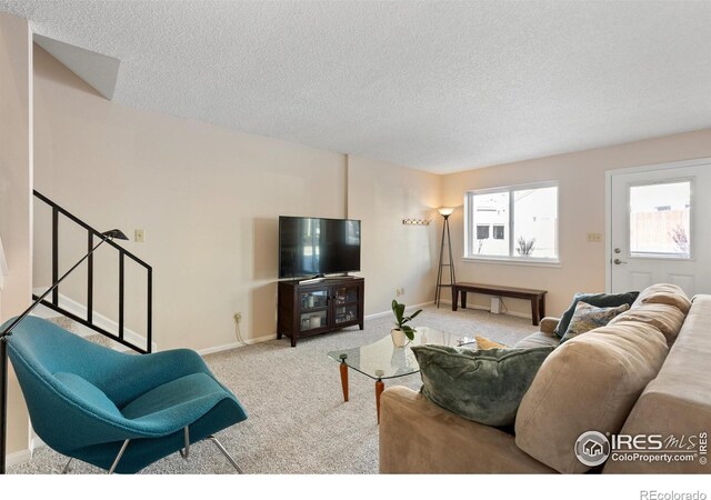 living room with light carpet and a textured ceiling