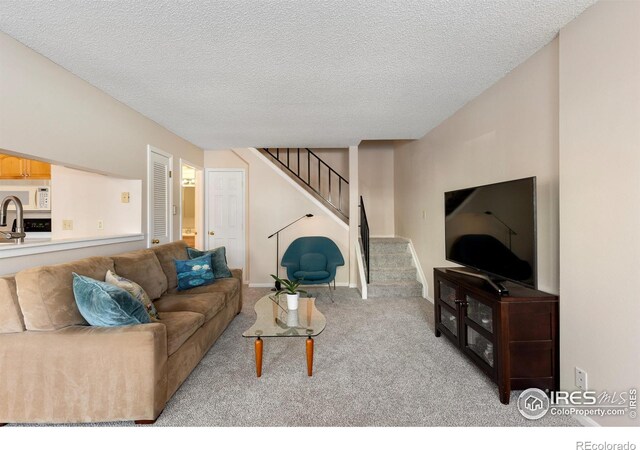 living room with light carpet and a textured ceiling