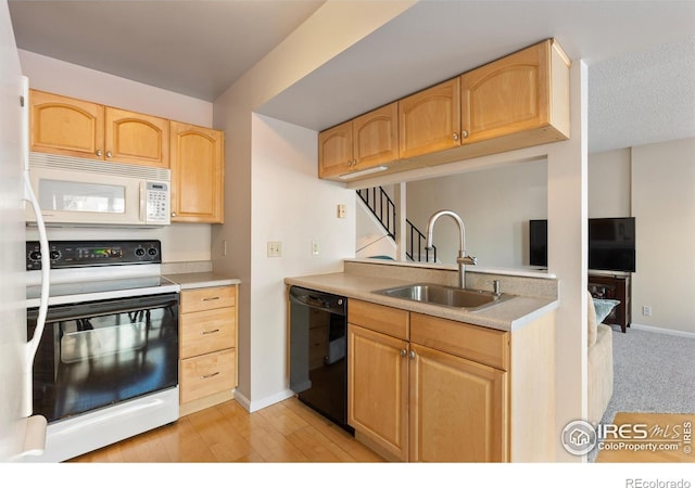 kitchen featuring light brown cabinetry, sink, range with electric cooktop, and dishwasher