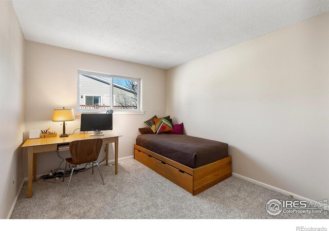 carpeted bedroom with a textured ceiling