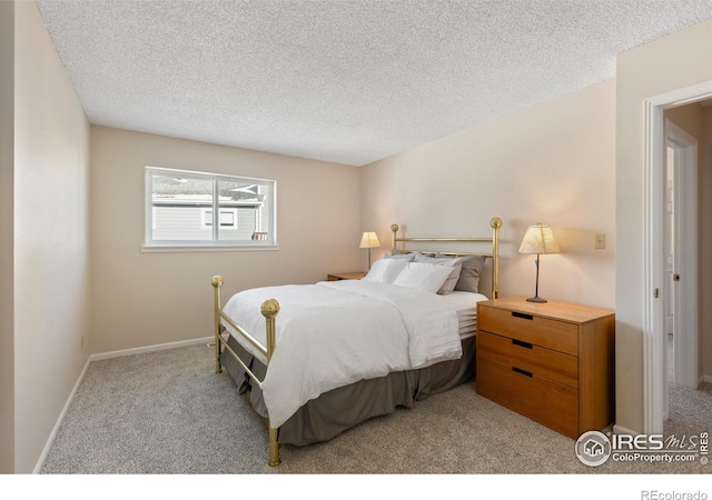 carpeted bedroom featuring a textured ceiling