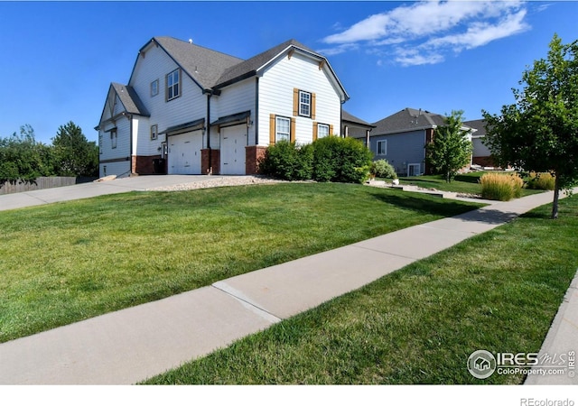 view of front of property featuring a garage, a front yard, brick siding, and driveway