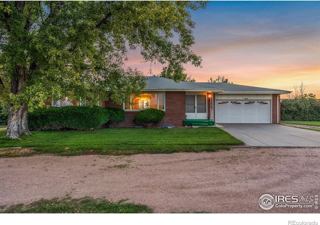 view of front of home featuring a garage and a lawn