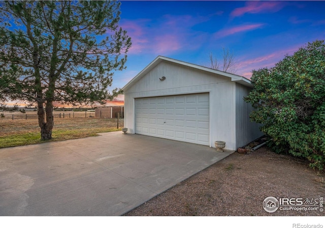 view of garage at dusk