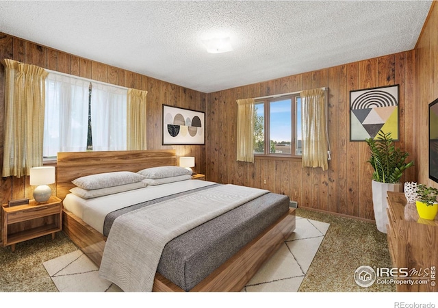 carpeted bedroom with wooden walls and a textured ceiling