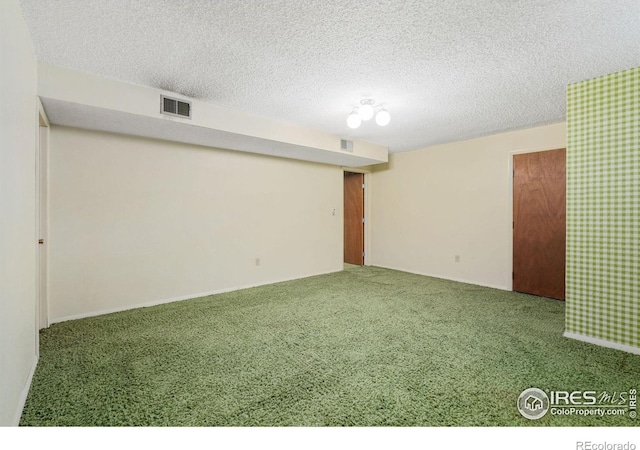 basement featuring a textured ceiling and carpet floors