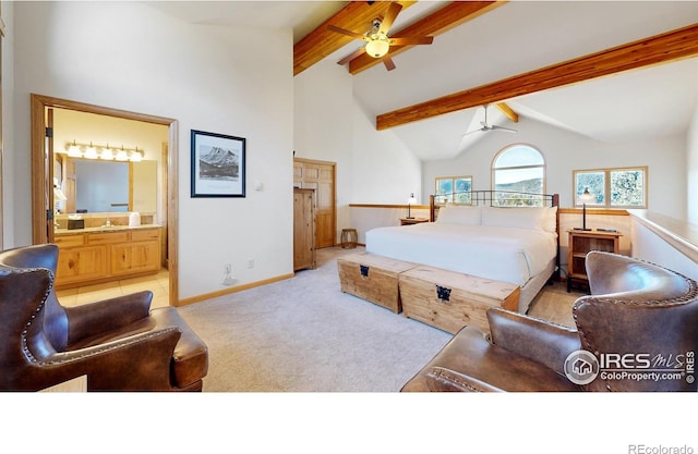 bedroom with ceiling fan, high vaulted ceiling, beam ceiling, ensuite bath, and light tile patterned floors