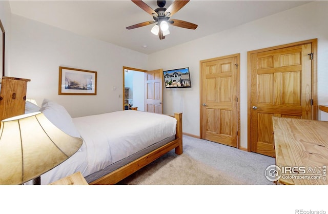 bedroom featuring ceiling fan and light carpet