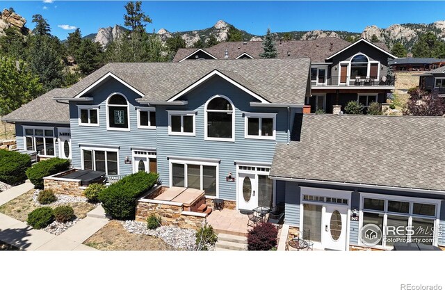 rear view of house with a mountain view and a garage