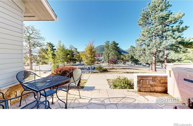 view of patio / terrace with a hot tub