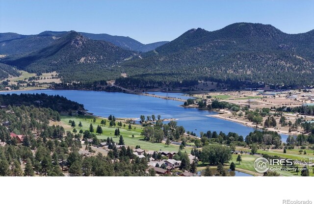 birds eye view of property with a water and mountain view