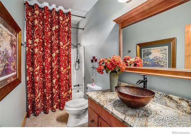 full bathroom with vanity, shower / bath combination with curtain, and toilet