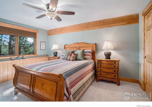 carpeted bedroom with a textured ceiling and ceiling fan