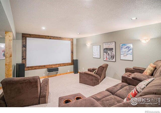 home theater room featuring carpet flooring, a textured ceiling, and baseboards