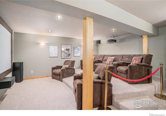 carpeted home theater with baseboards, a textured ceiling, and recessed lighting