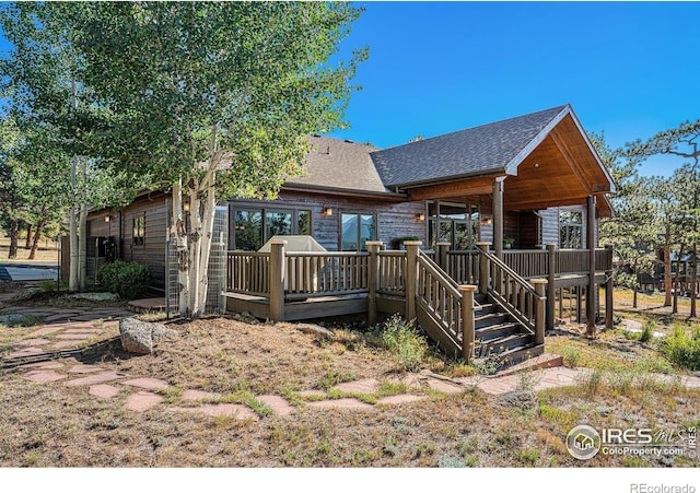 rear view of property featuring a deck