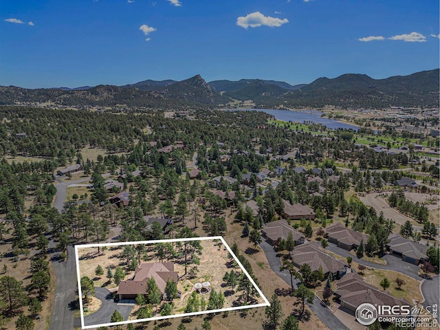 drone / aerial view featuring a water and mountain view