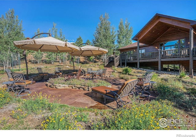 view of yard with an outdoor fire pit, a deck, and a patio