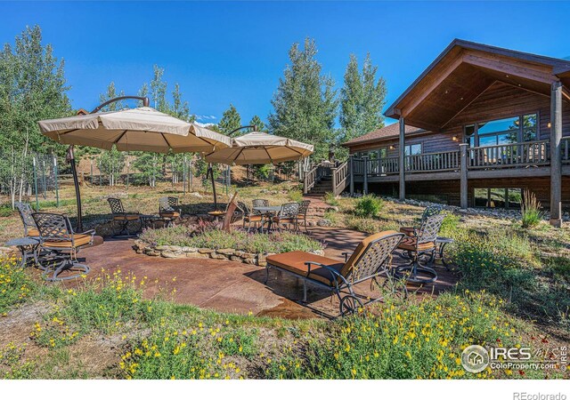 view of yard with a deck, a fire pit, stairs, a gazebo, and a patio area