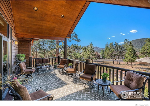 deck with a patio and a mountain view