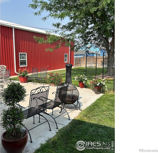 view of patio / terrace with an outdoor fire pit and fence