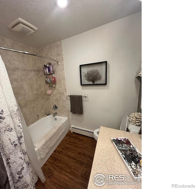 bathroom with a textured ceiling, a baseboard radiator, toilet, wood finished floors, and shower / tub combo with curtain