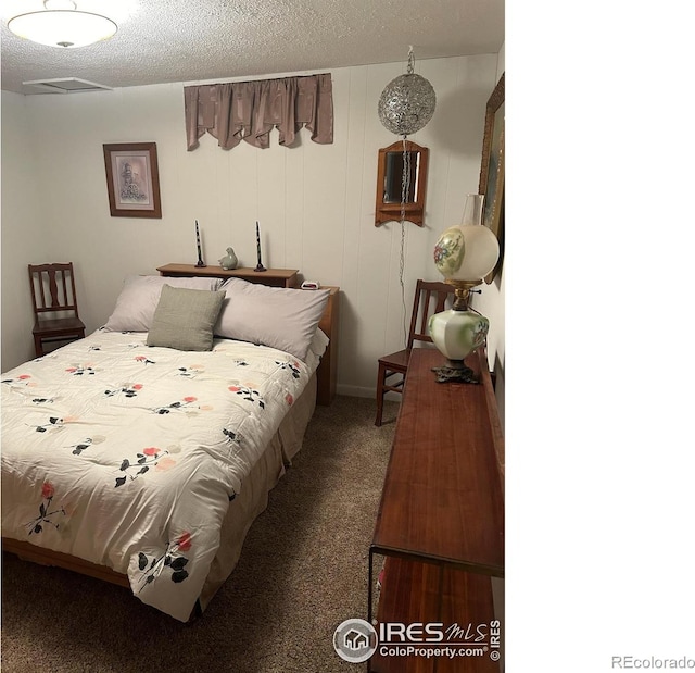 carpeted bedroom with a textured ceiling