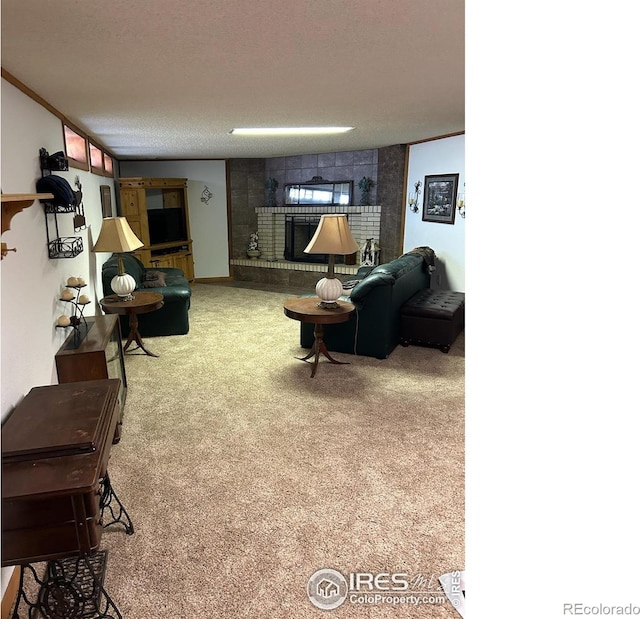 living room with crown molding, carpet flooring, a fireplace, and a textured ceiling