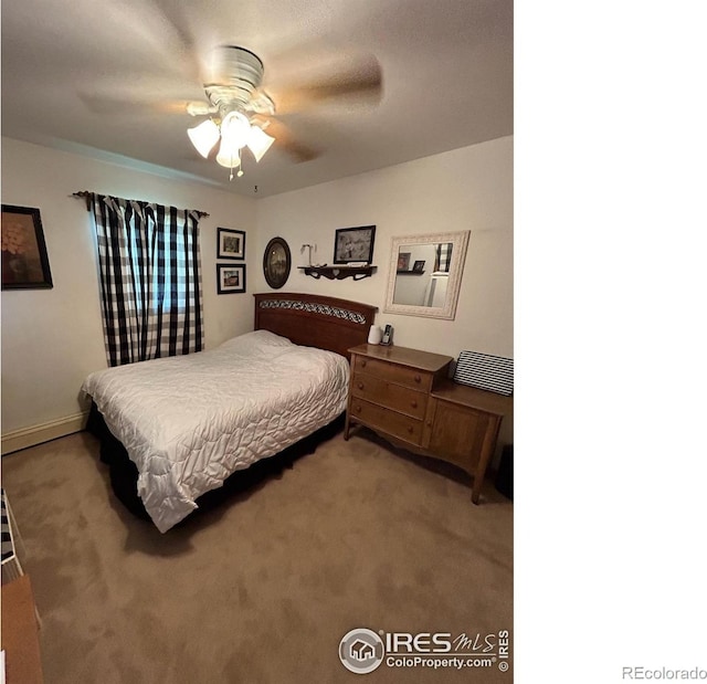 bedroom with a ceiling fan, light colored carpet, and baseboards