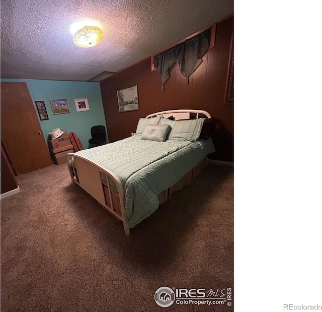 carpeted bedroom featuring a textured ceiling