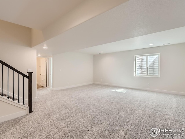 basement featuring light carpet