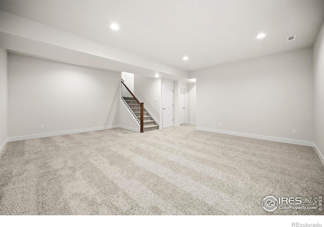 basement featuring light carpet