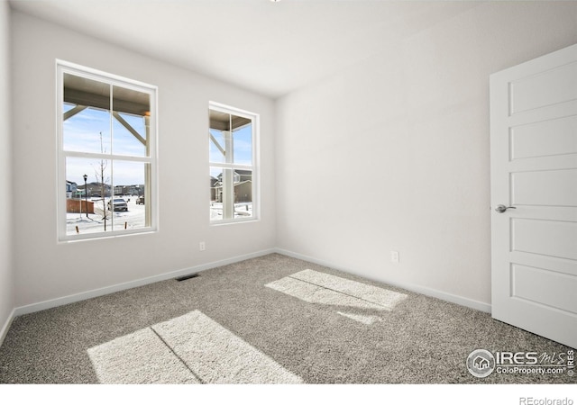 unfurnished room featuring carpet flooring