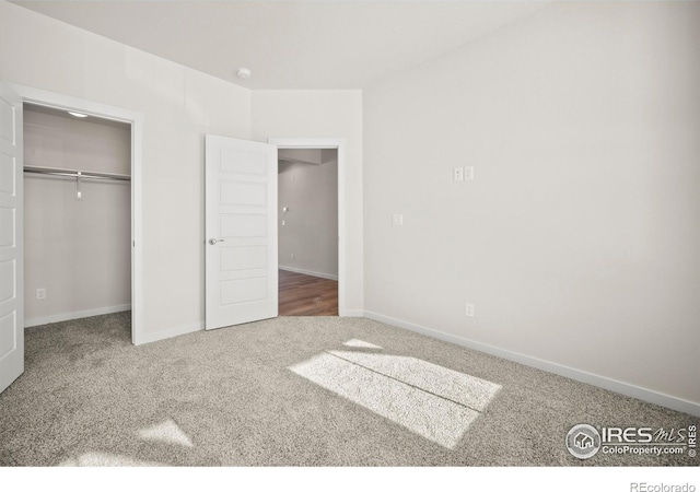 unfurnished bedroom with carpet floors and a closet