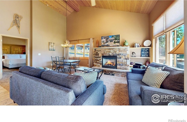 living room with light wood-type flooring, high vaulted ceiling, wooden ceiling, a fireplace, and beamed ceiling