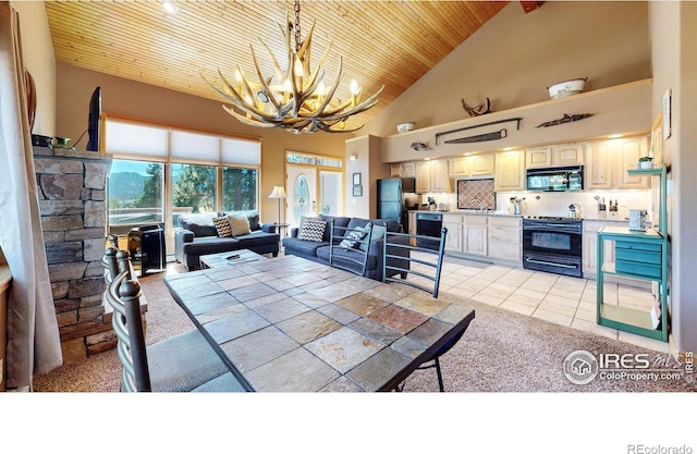 349 Overlook Ln, Estes Park, CO 80517 - dining space with wooden ceiling, a chandelier, high vaulted ceiling, light colored carpet, and light tile patterned floors