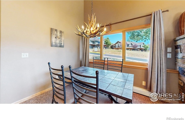 dining room featuring carpet floors, an inviting chandelier, and a baseboard radiator