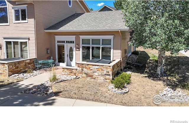 349 Overlook Ln, Estes Park, CO 80517 - property entrance featuring stone siding and roof with shingles