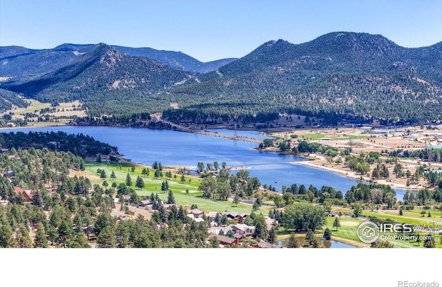 birds eye view of property with a water and mountain view