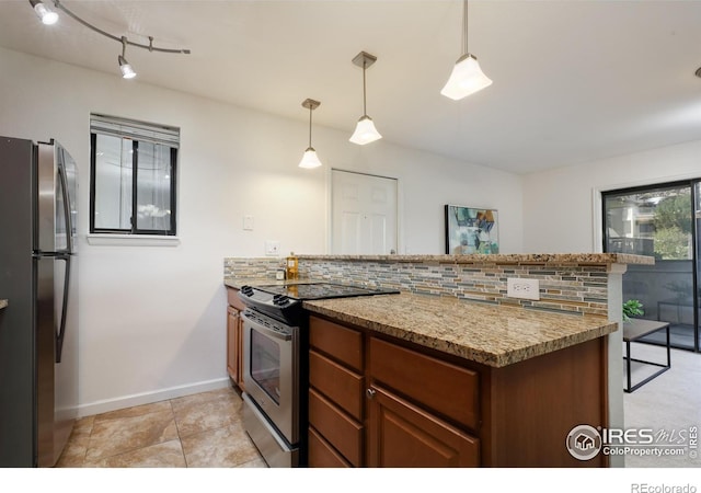 kitchen with light stone counters, appliances with stainless steel finishes, kitchen peninsula, pendant lighting, and backsplash