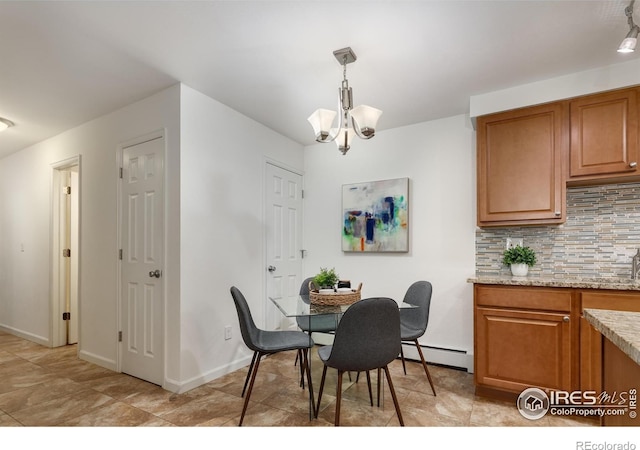 dining room with an inviting chandelier and a baseboard heating unit