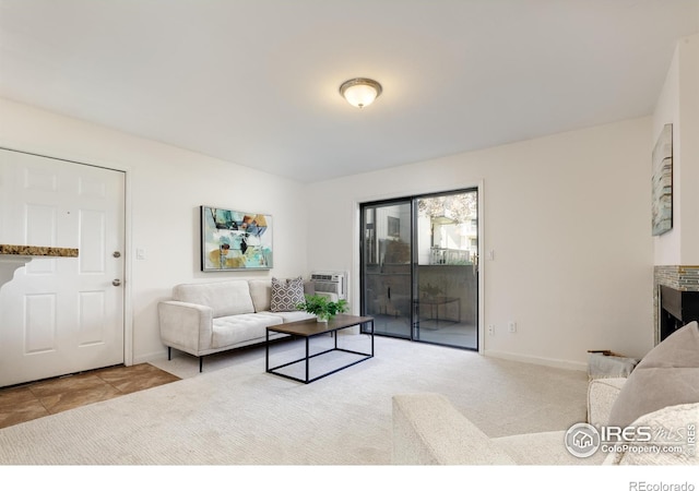 carpeted living room with a wall unit AC and baseboards