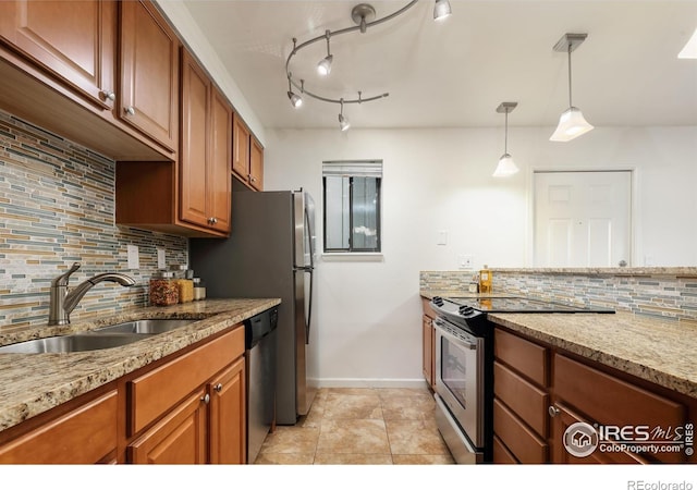 kitchen featuring a sink, light stone counters, brown cabinets, and appliances with stainless steel finishes