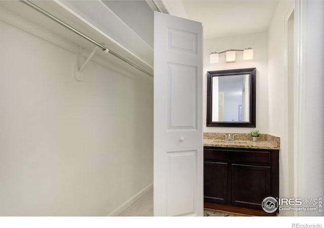 bathroom featuring vanity and baseboards