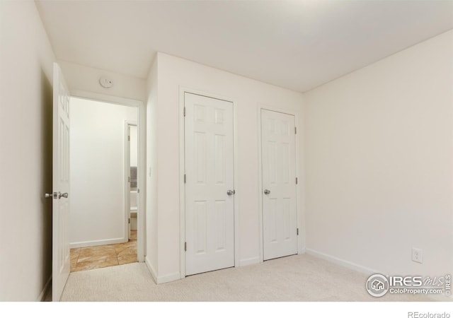 unfurnished bedroom featuring baseboards and carpet floors