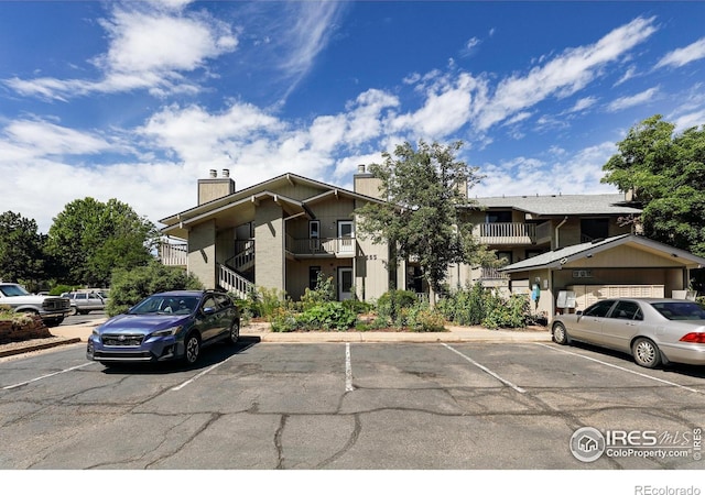 view of building exterior featuring uncovered parking