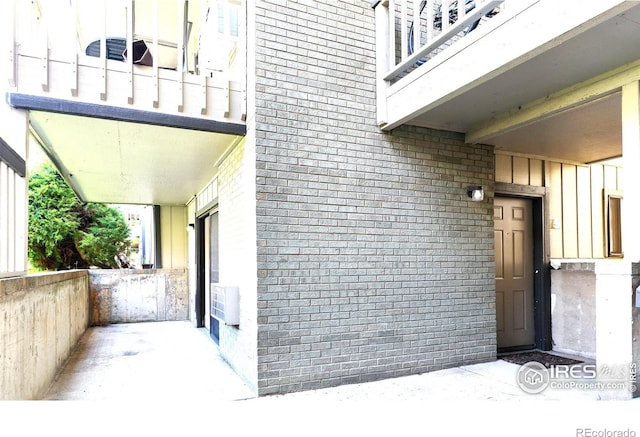 doorway to property featuring brick siding