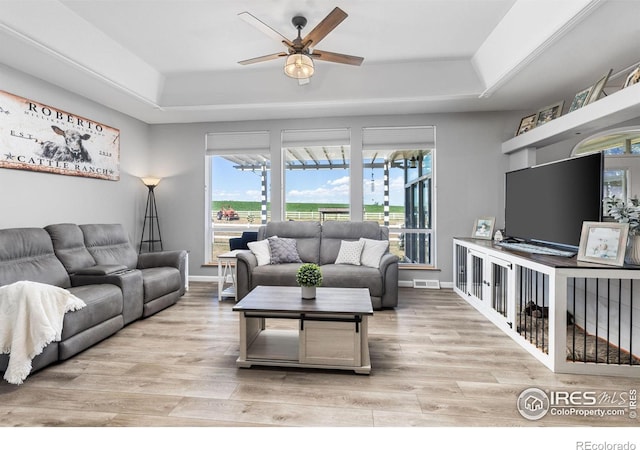 living room with ceiling fan, hardwood / wood-style flooring, and a wealth of natural light