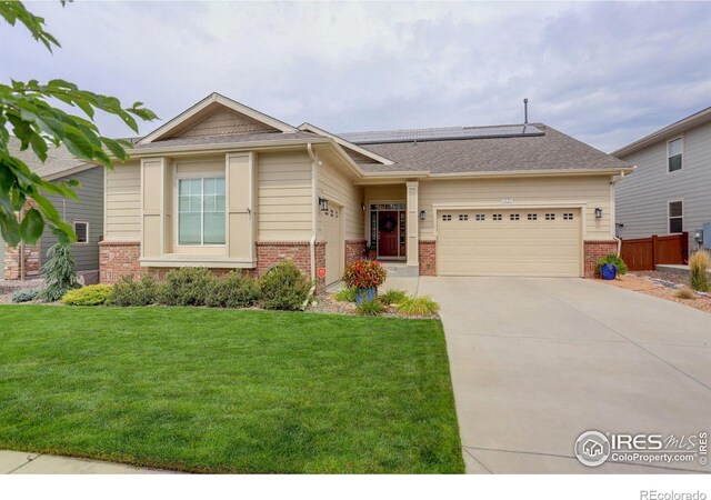 view of front of house featuring a front lawn and a garage